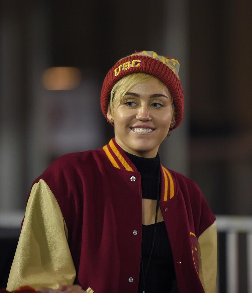 Miley Cyrus looked like a USC Trojans fan in cardinal and gold gear at the football game Thursday against Cal.