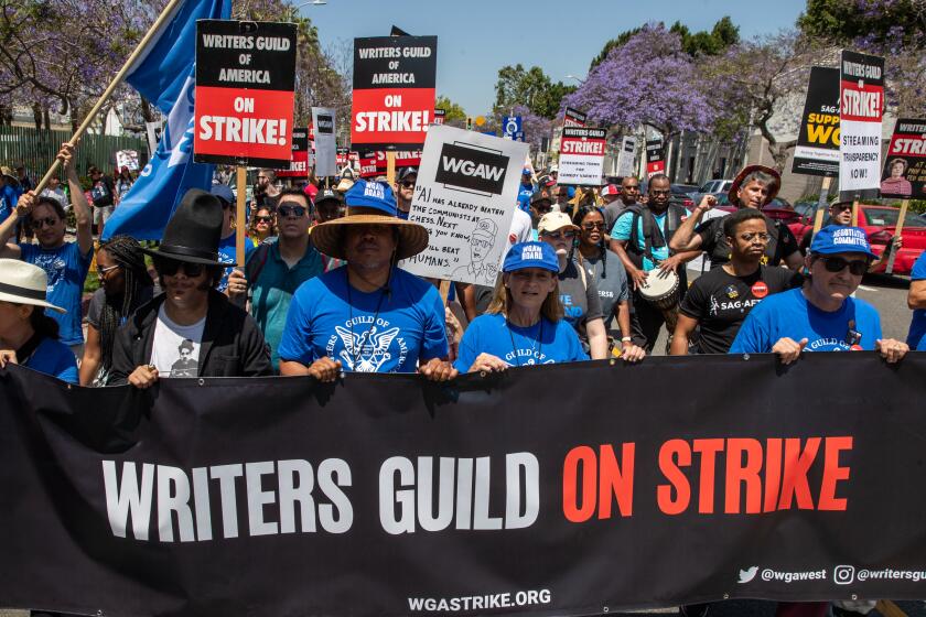 LOS ANGELES, CA - JUNE 21: Striking members of the Writers Guild of America and supporters march towards La Brea Tar Pits, Los Angeles, CA. (Irfan Khan / Los Angeles Times)