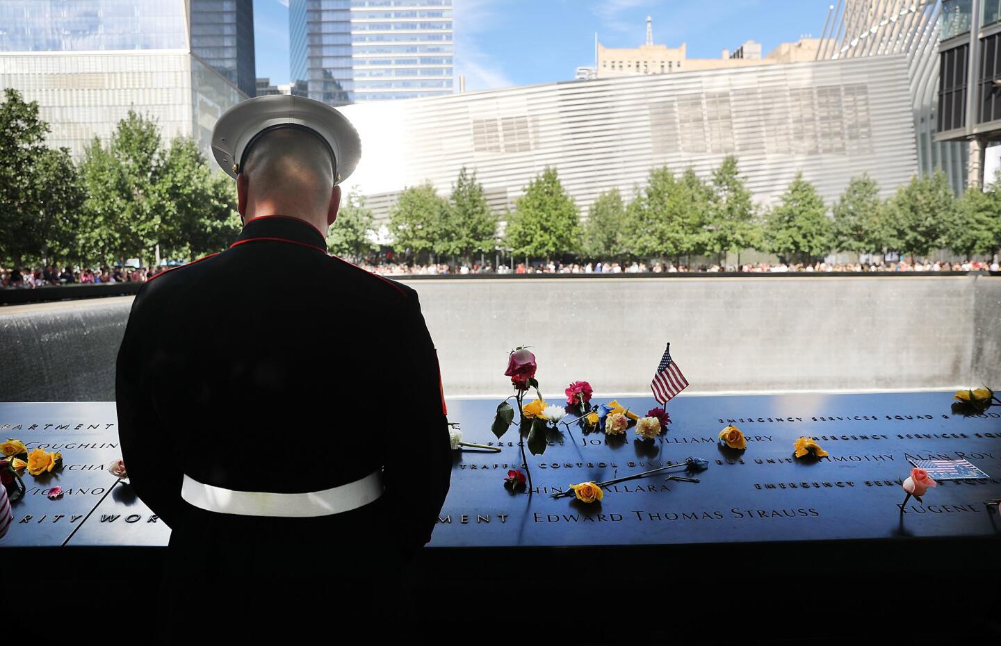 A U.S. Marine pauses at one of the pools at the National September 11 Memorial following a morning commemoration ceremony for the victims of the terrorist attacks fifteen years after the day on September 11, 2016 in New York City.