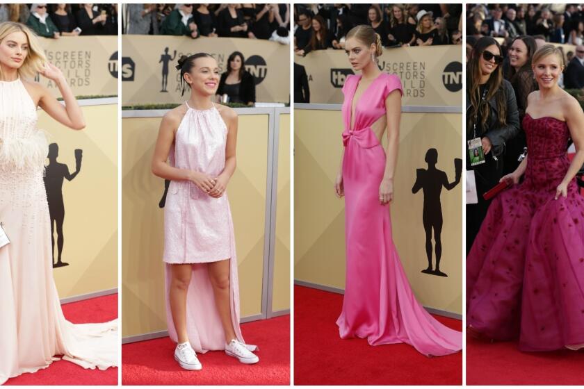 The parade of pink at the 24th annual SAG Awards included, from left, Margot Robbie in a pastel pink silk crepe chiffon Miu Miu gown with ostrich feather empire waist detail; Millie Bobby Brown in a pre-spring 2018 rose sequined Calvin Klein cocktail dress with gathered neckline, fitted waist and high-low hem; Samara Weaving in a fuchsia Miu Miu gown with gathered draped bow and deep neckline detail and host Kirsten Bell in a fuchsia J. Mendel gown.