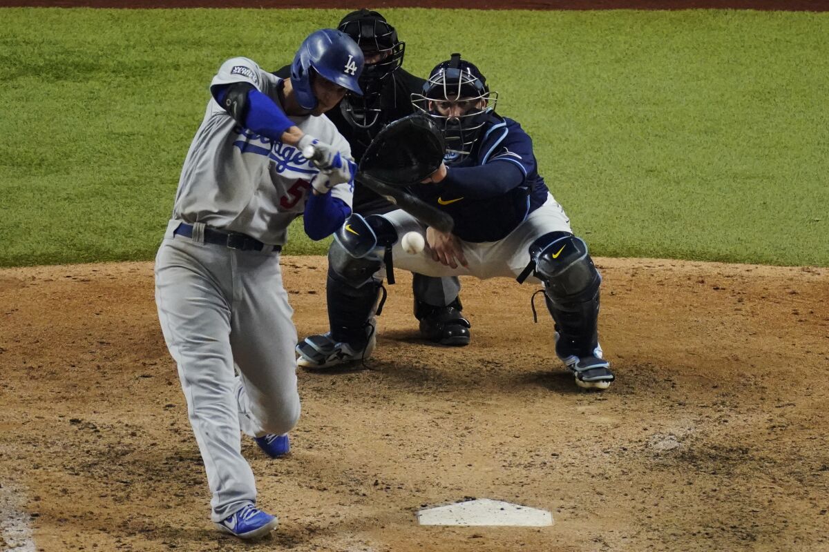 Dodgers shortstop Corey Seager hits a run-scoring single in the eighth inning.