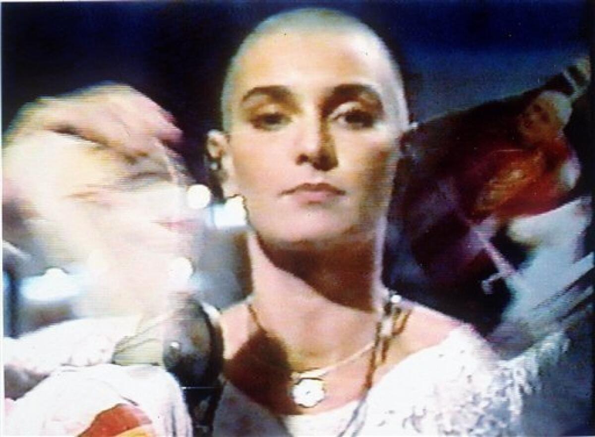 FILE - In this Oct. 5, 1992 image from video released by NBC, singer Sinead O'Connor tears up a photo of Pope John Paul II during a live appearance in New York on NBC's Saturday Night Live. (AP Photo/NBC, file)