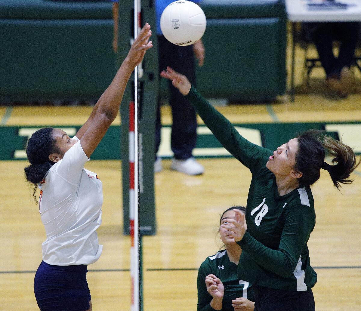 Providence's Jenelle Idian, right, battles against Polytechnic's Laila Ward for the ball at the top of the net in a Prep League girls' volleyball match at Providence High School on Tuesday, September 17, 2019.