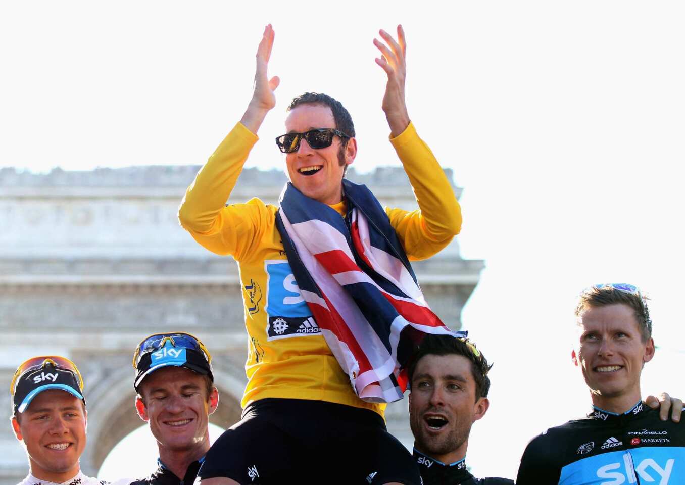 Bradley Wiggins of Great Britain on the Sky Pro Cycling team, top, celebrates with teammates Edvald Boasson Hagen, left, Michael Rogers, Bernhard Eisel and Christian Knees after winning the 2012 Tour de France last Sunday.