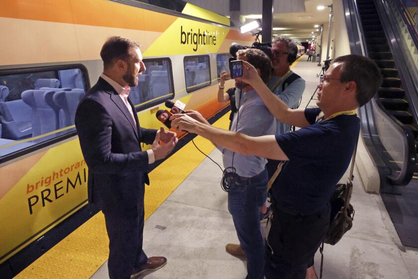 Brightline president Patrick Goddard talks to media as the first Brightline train to Miami prepares to depart in the debut of service from Orlando International Airport, early Friday, Sept. 22, 2023. The high-speed Orlando-Miami route marks first new privately-owned inter-city passenger service to roll out in the U.S. in 100 years. (Joe Burbank /Orlando Sentinel via AP)