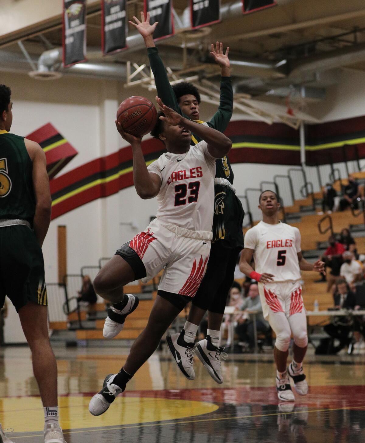 Etiwanda's Marcus Green (23) drives to the basket against Damien's Chris Nickelberry.