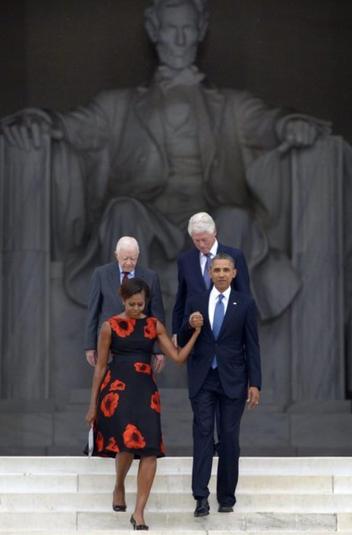 President Obama escorts First Lady Michelle Obama with former presidents Jimmy Carter and Bill Clinton during ceremonies at the Lincoln Memorial marking the 50th anniversary of the March on Washington.