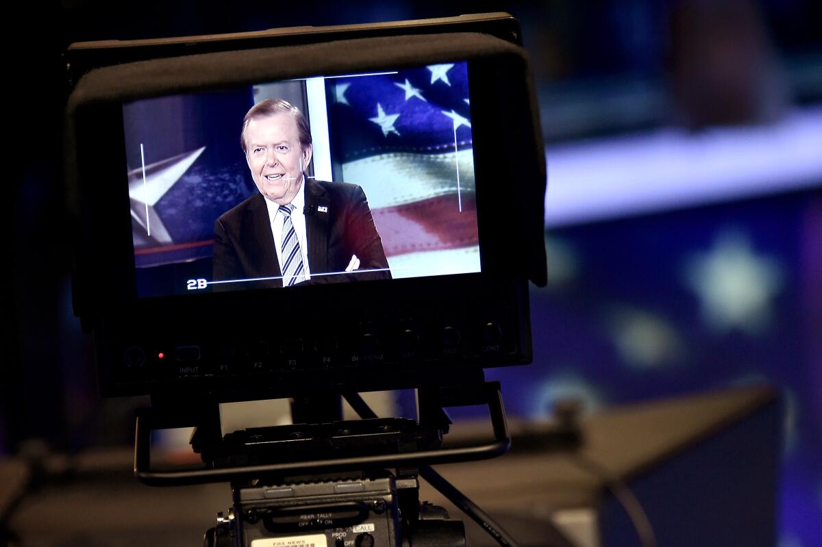 Lou Dobbs is seen on a television screen at Fox Business Network Studios