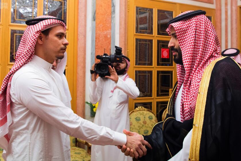 FILE - In this Oct. 23, 2018, file photo released by Saudi Press Agency, Salah Khashoggi, left, a son of Jamal Khashoggi, shakes hands with Saudi Crown Prince Mohammed bin Salman in Riyadh, Saudi Arabia. The family of slain Washington Post columnist Jamal Khashoggi announced Friday, May 22, 2020 that they have forgiven his Saudi killers, giving automatic legal reprieve to the five government agents convicted of his murder who’d been sentenced to execution. (Saudi Press Agency via AP, File)