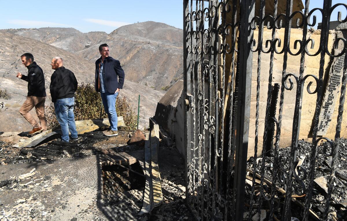 Los Angeles Mayor Eric Garcetti, left, City Councilman Mike Bonin and California Gov. Gavin Newsom view a burned home on Tigertail Road in Brentwood on Tuesday.