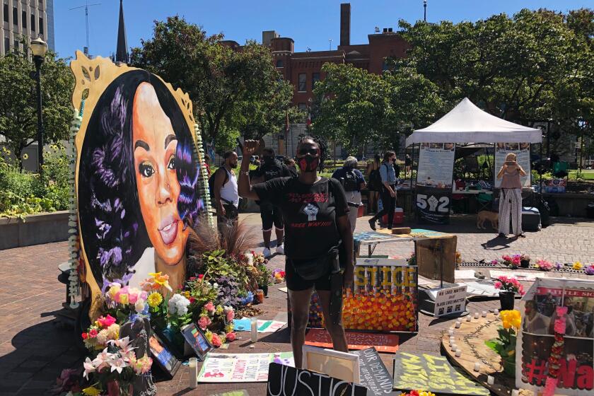 Rosie Henderson, 47, of Louisville said she doesn't approve of militias attending protests or coming to the memorial to Breonna Taylor in downtown Louisville. "This is a loving place, a healing place, so keep that gun-toting away," she said.