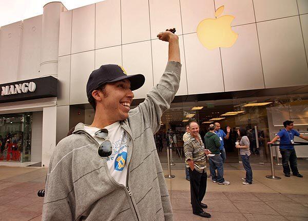 Cole Rich shows off his new iPhone, exclaiming, "It's better than losing your virginity." He purchased the phone at the Apple store on the Third Street Promenade in Santa Monica after waiting in line with hundreds of customers.