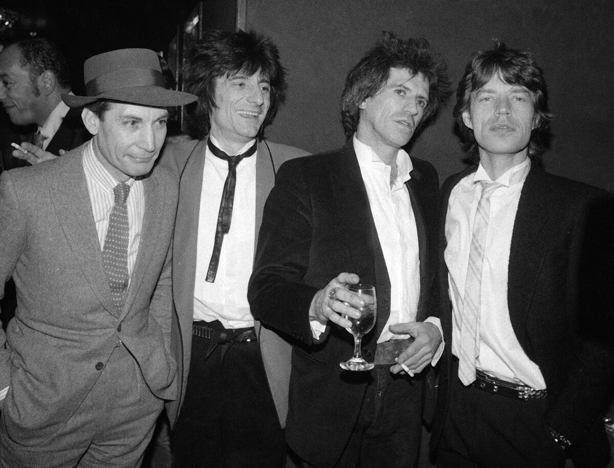 A black-and-white photo of Rolling Stones Charlie Watts, Ron Wood, Keith Richards and Mick Jagger in New York in 1983. 
