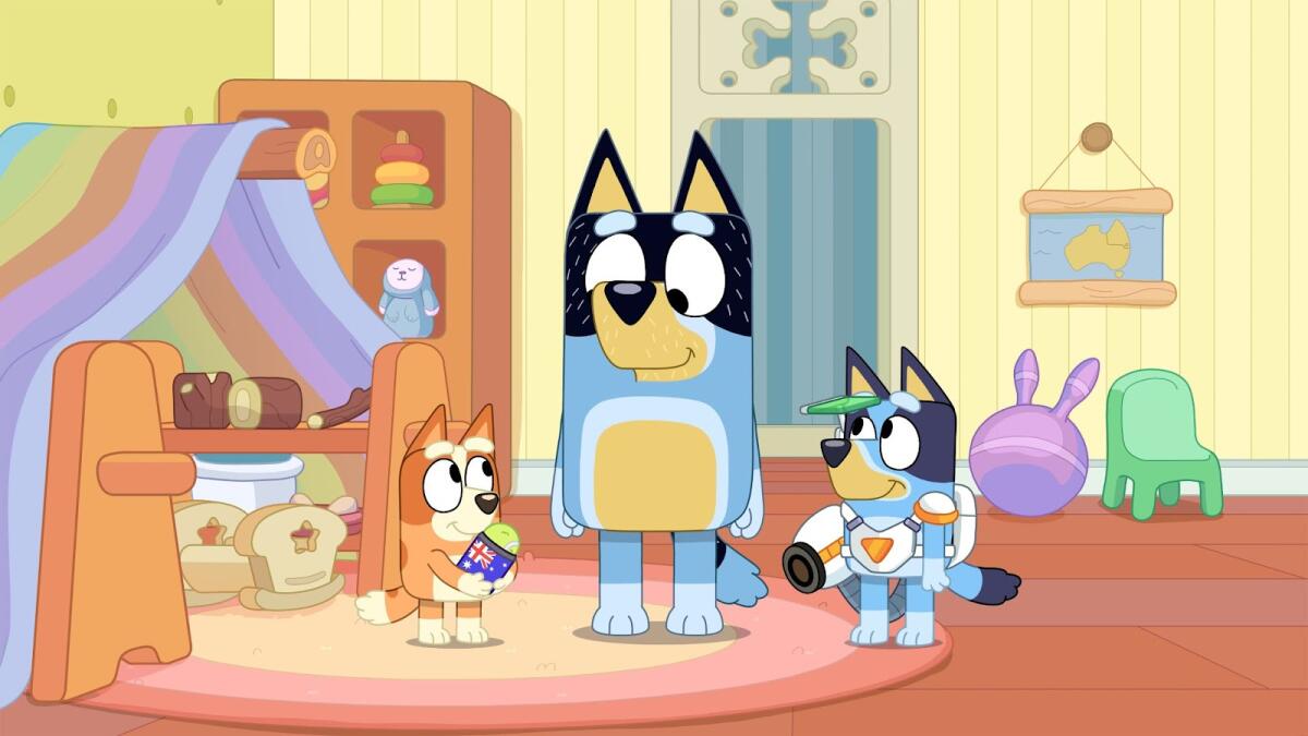 Three animated dogs stand in a room.