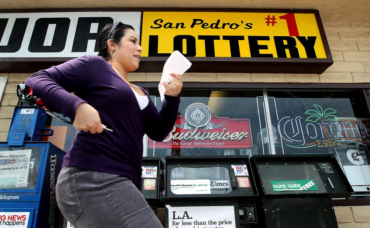 A lottery player in San Pedro hurries to Mr. C's Liquor in San Pedro in 2012, when a $656 million lottery jackpot, the largest ever was split among winners in three states.