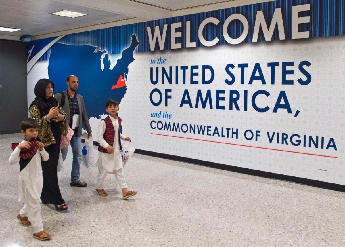 In this June 29, 2017, photo, international travelers leave the Customs and Immigration area of Dulles International Airport (IAD) outside Washington, DC, in Dulles, Virginia.