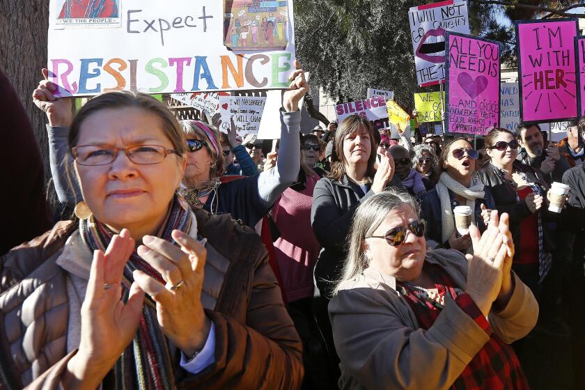 Demonstrators applaud speakers in support of the Women's March on Washington at the Arizona Capitol Saturday, Jan. 21, 2017, in Phoenix. Thousands of protesters in Phoenix joined in support of those in cities around the globe protesting against Donald Trump as the new United States president. (AP Photo/Ross D. Franklin)
