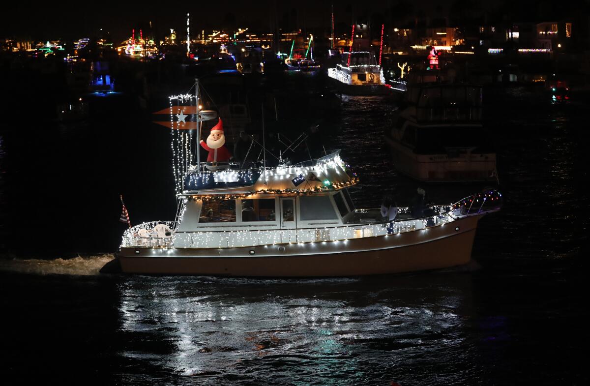 Vessels playing Christmas music make a turn at the Balboa Bridge.