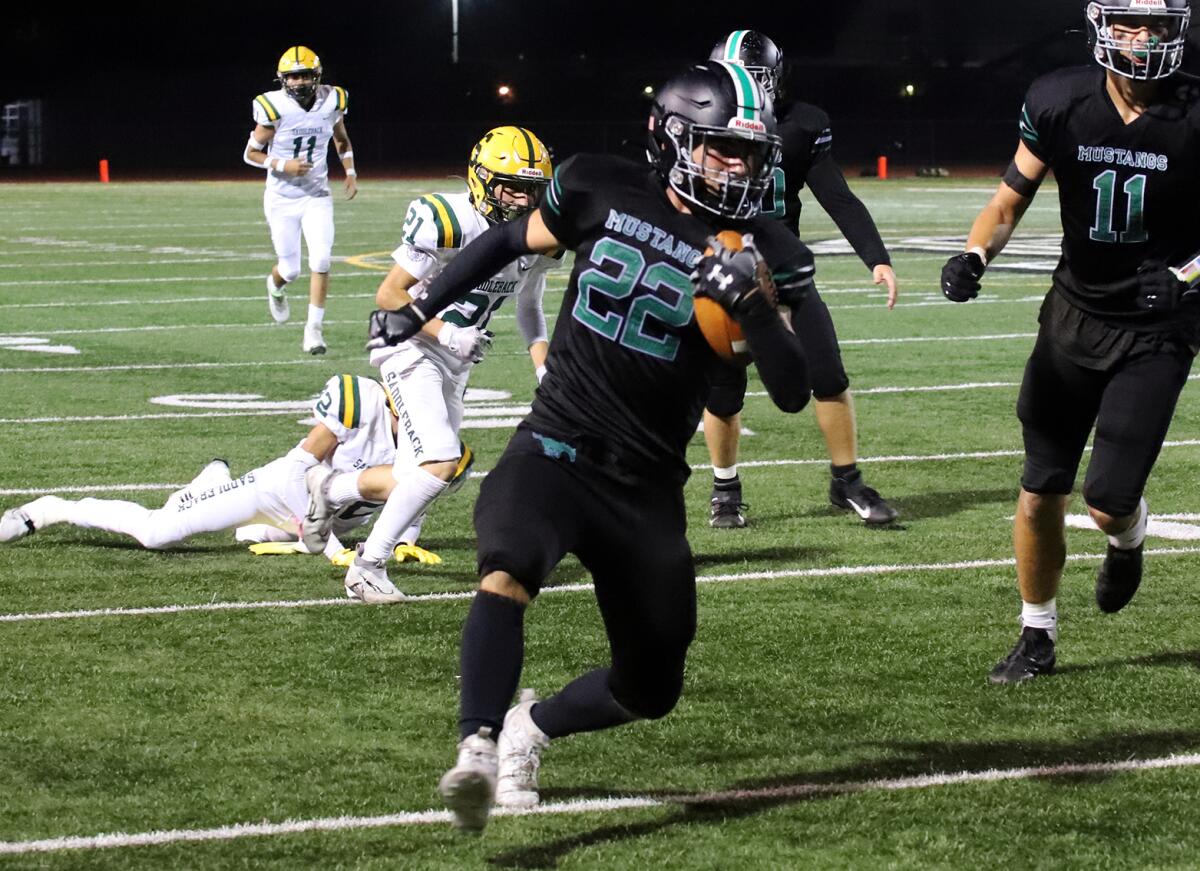 Costa Mesa's Brett McDonough (22) runs with the ball against Saddleback in an Orange Coast League game on Friday.