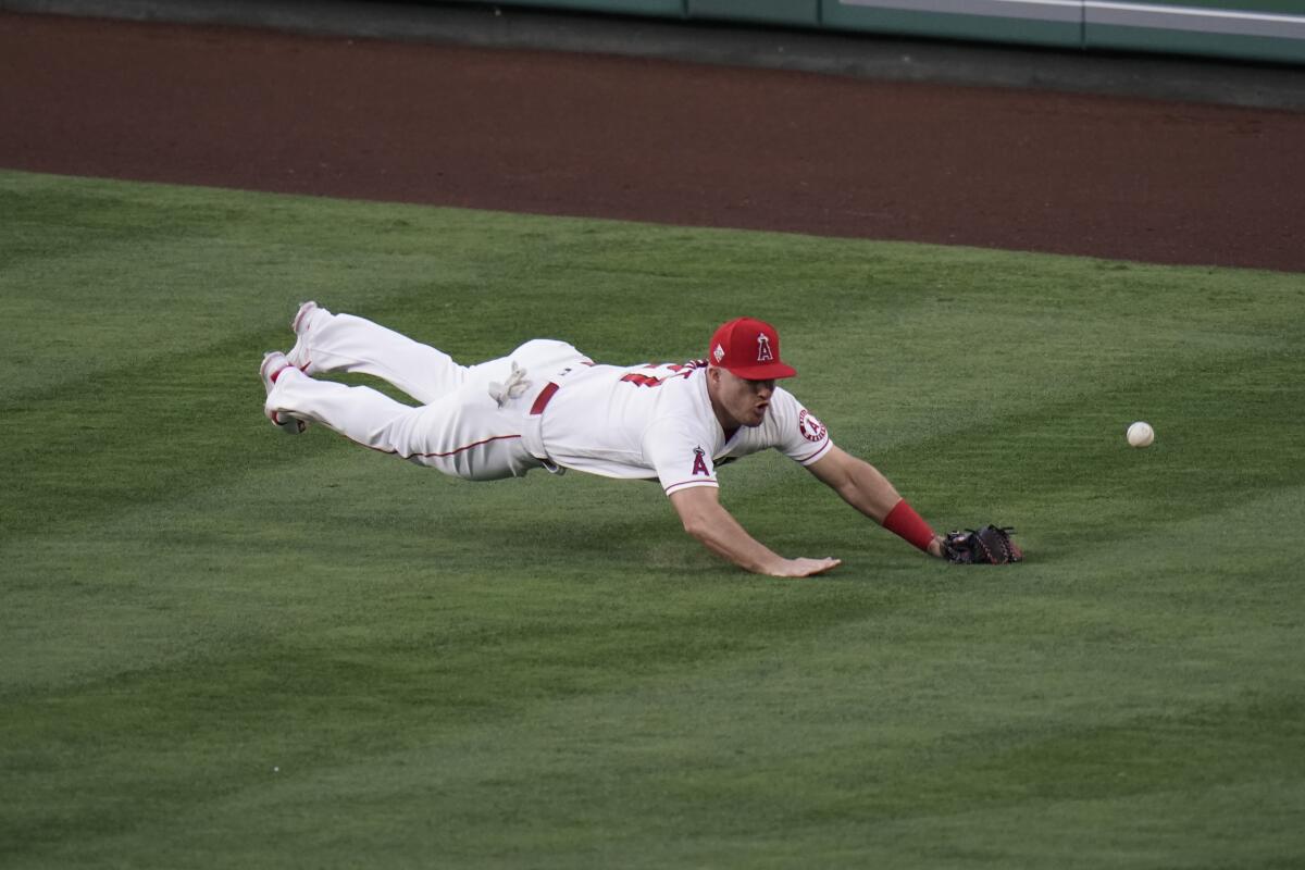 Angels center fielder Mike Trout can't make a diving catch on a double hit by the Dodgers' AJ Pollock.