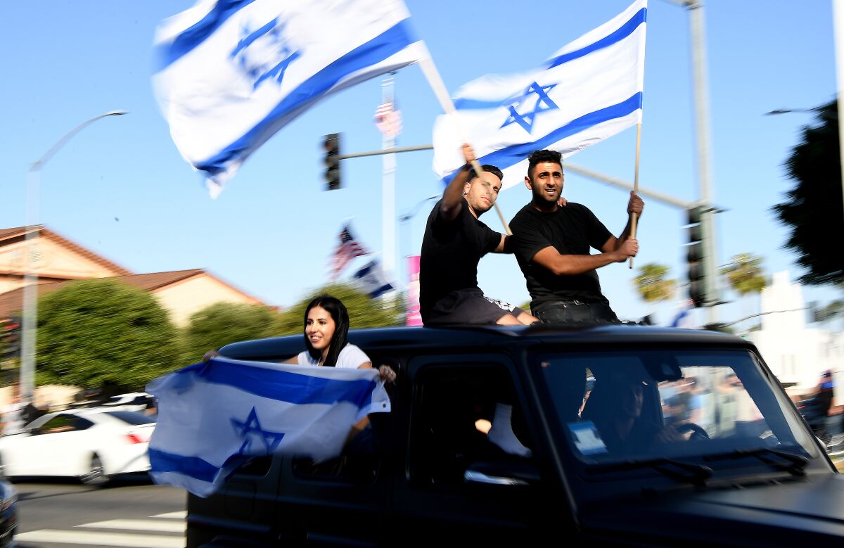 Demonstrators wave Israeli flags during a protest in Beverly Hills against antisemitism on May 23.