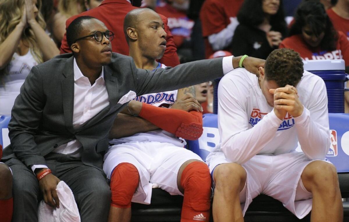 Maalik Wayns interacts with Blake Griffin during a game.