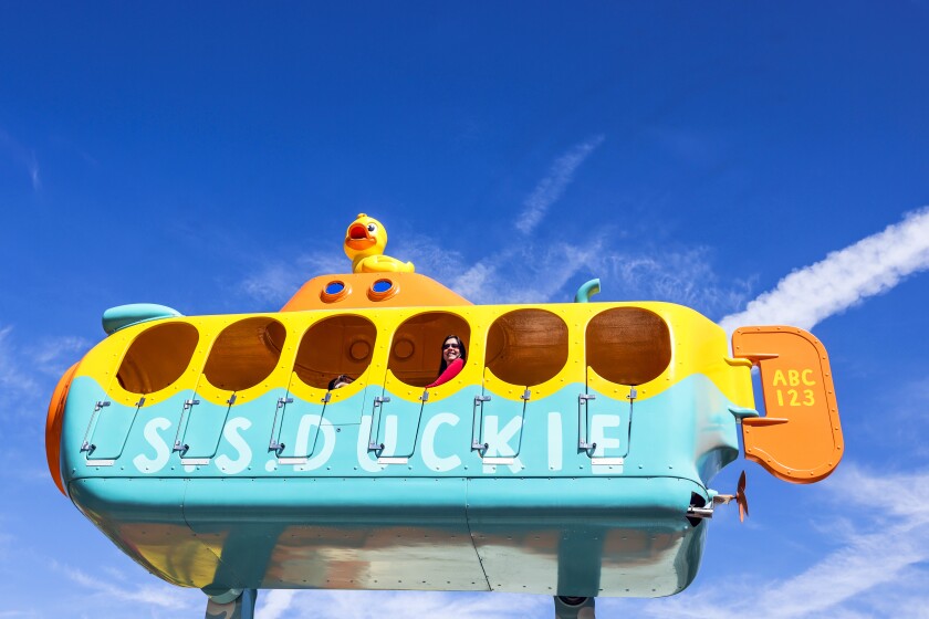 A woman smiles aboard the Rub-A-Dub Sub ride at Sesame Place