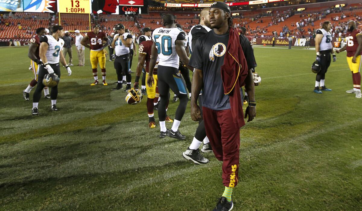 Washington Redskins quarterback Robert Griffin III walks off the field after an NFL preseason football game against the Jacksonville Jaguars on Sept. 3.