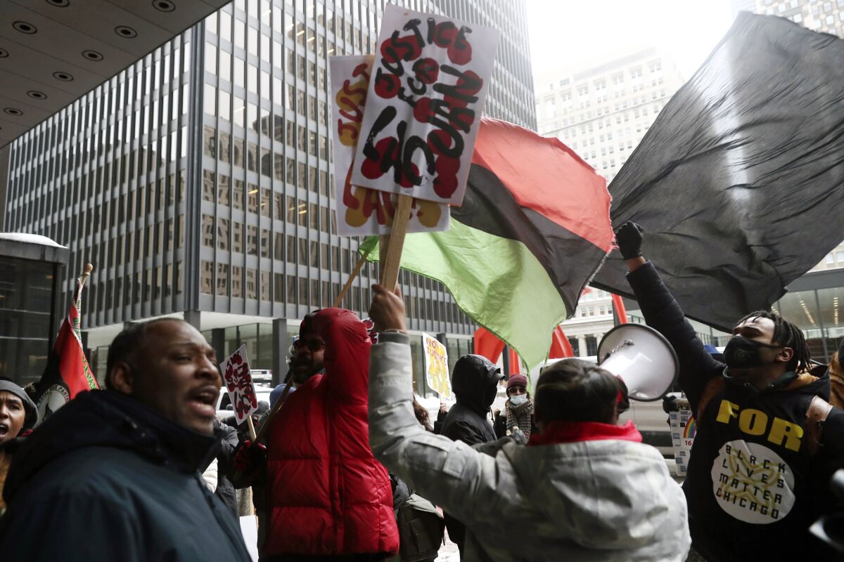 Protesters call for federal civil rights charges during a rally after former Chicago police officer Jason Van Dyke was released from prison Thursday, Feb. 3, 2022 at Federal Plaza in Chicago. Former Chicago police Officer Jason Van Dyke left prison on Thursday after serving less than half of his nearly seven-year sentence for killing Black teenager Laquan McDonald, angering community leaders who feel the white officer's punishment didn't fit his crime.. (John J. Kim/Chicago Tribune via AP)
