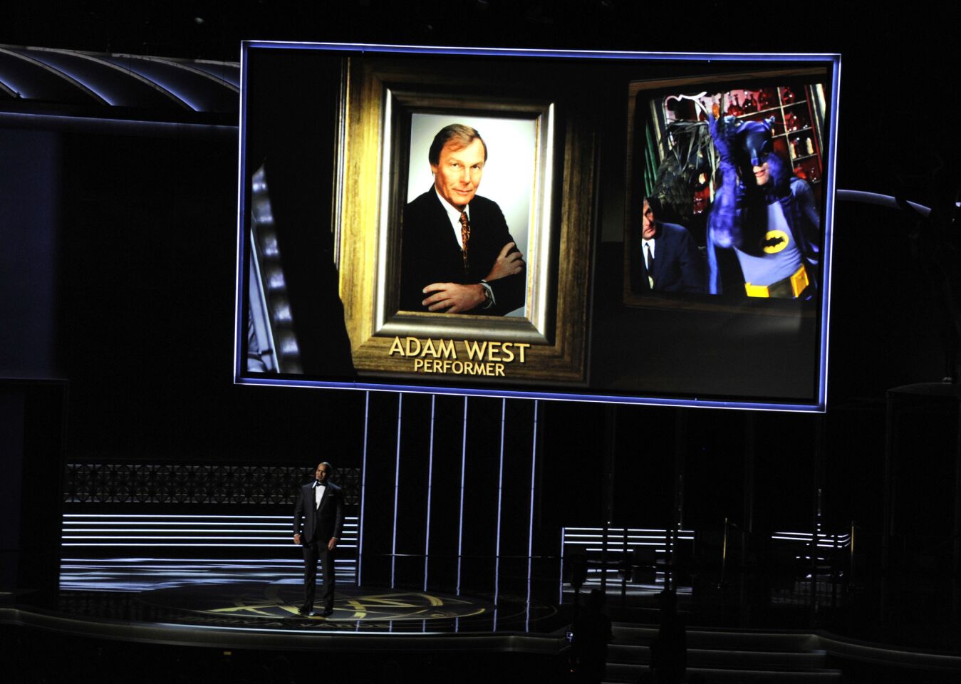 Christopher Jackson sings as a picture of Adam West appears on-screen during an in memoriam tribute at the 69th Emmy Awards.