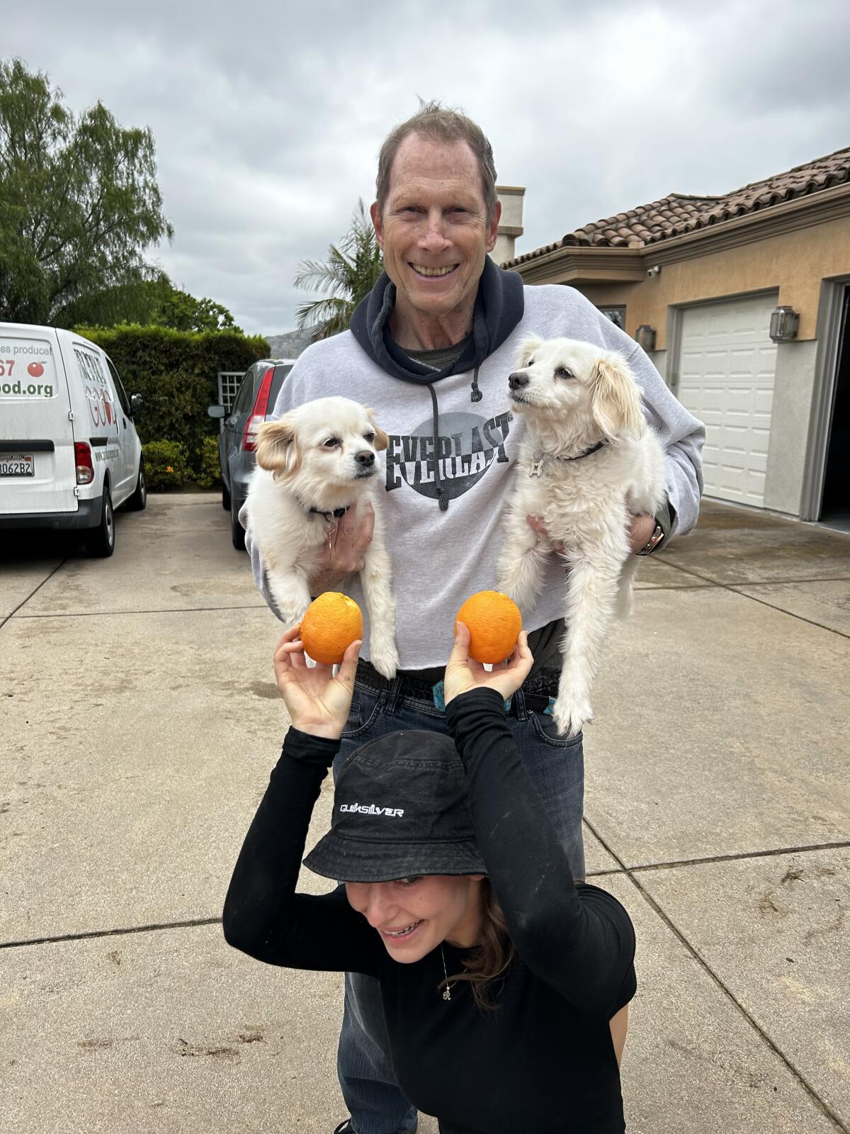 Homeowner Jim Sleeper and his pups Max and Mini were proud to be on the scene for the orange picking event.