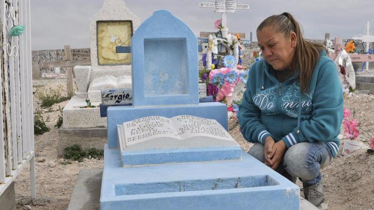 Maria Guadalupe Guereca, 60, visits the grave of son Sergio Hernandez at the Jardines del Recuerdo cemetery in Ciudad Juarez, Mexico.