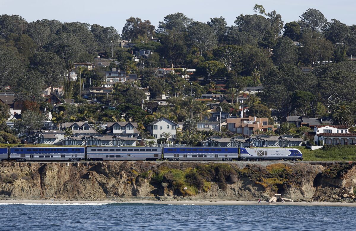 The Amtrak Surfliner train heads north along the tracks in Del Mar where bluffs toward the ocean regularly collapse on Dec. 5, 2019.