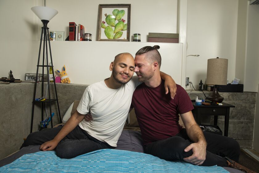 CITY TERRACE, CA-DECEMBER 5, 2019: Jose Guevara-Johnson, left, 25, and husband, Stephen Guevara-Johnson, 29, are photographed at their home in City Terrace on December 5, 2019. Jose is a DACA recipient and in cancer remission. Stephen is a U.S. citizen. The couple decided to marry despite Jose’s precarious situation. (Mel Melcon/Los Angeles Times)