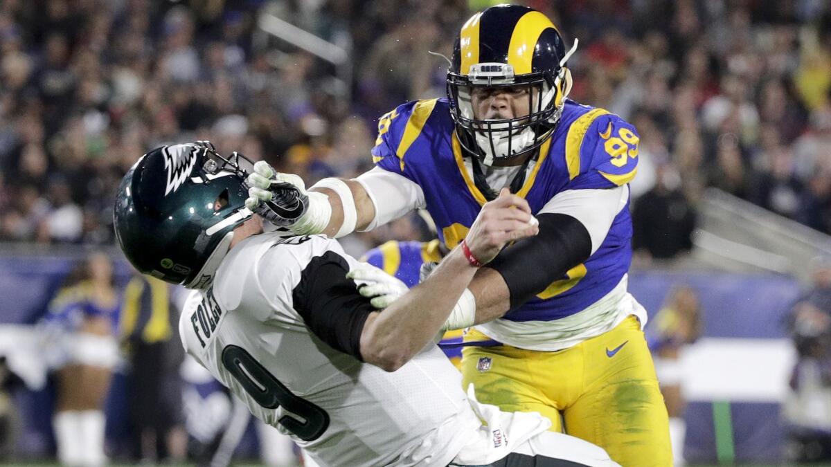 Rams defensive end Aaron Donald hits Philadelphia quarterback Nick Foles during a Dec. game.