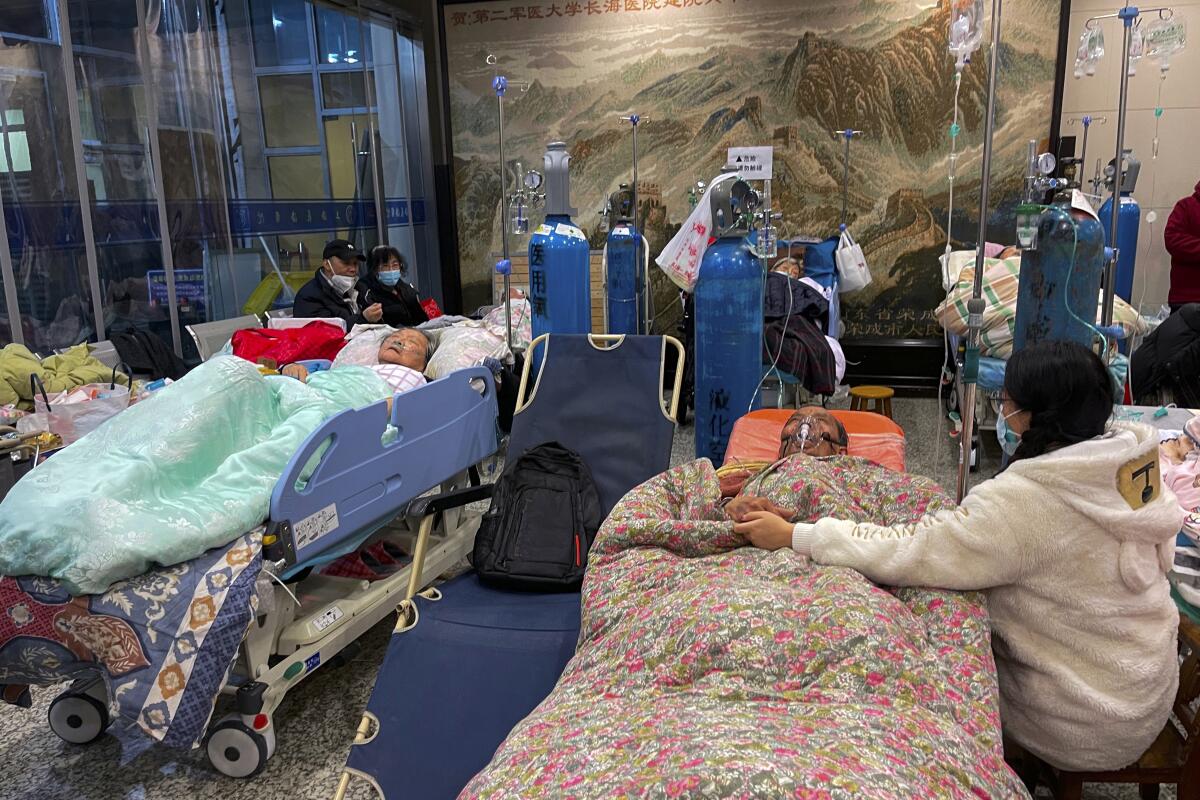 Patients receive intravenous drips while using  ventilators in a hallway at the Changhai Hospital in Shanghai, China.