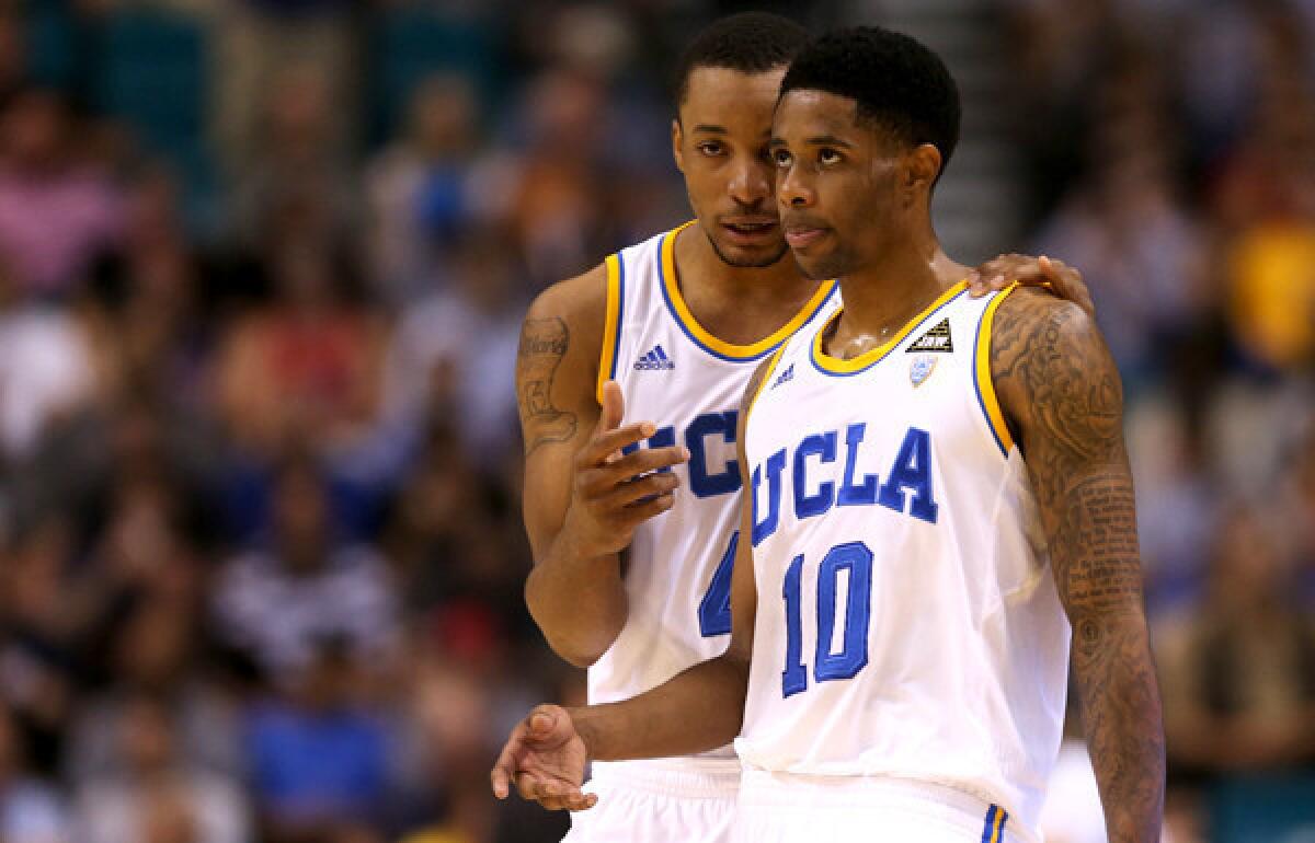 Bruins guards Norman Powell and Larry Drew II (10) talk strategy during the Pac-12 Conference tournament championship game.