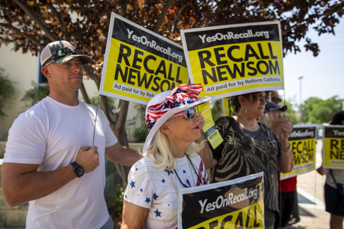 Vicky Abramson, middle, of Valencia attends a rally in Santa Clarita to support recalling Newsom. 