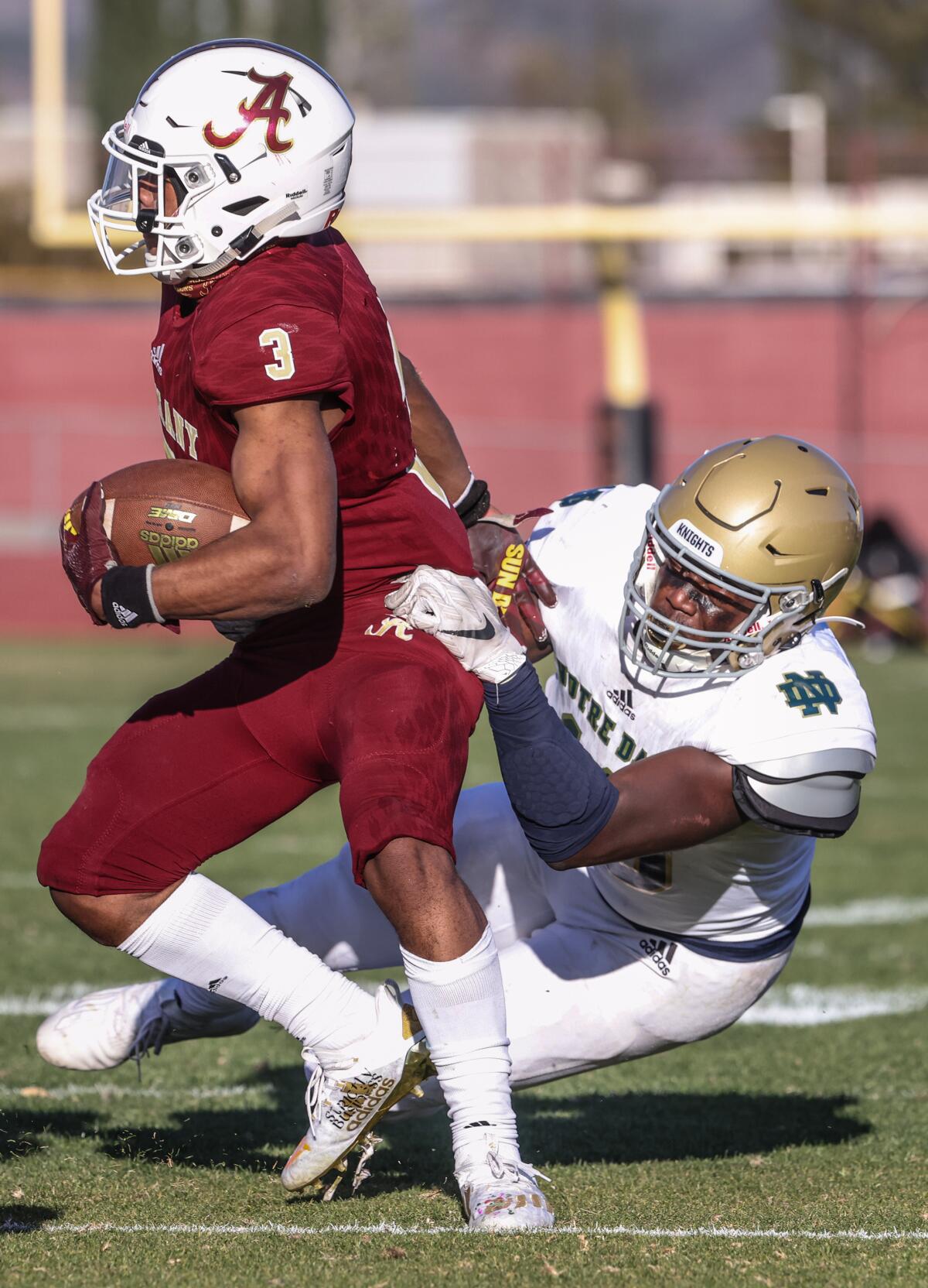  Sherman Oaks Notre Dame defensive end Sulayman Adeoye tackles Bishop Alemany Floyd Chalk IV.