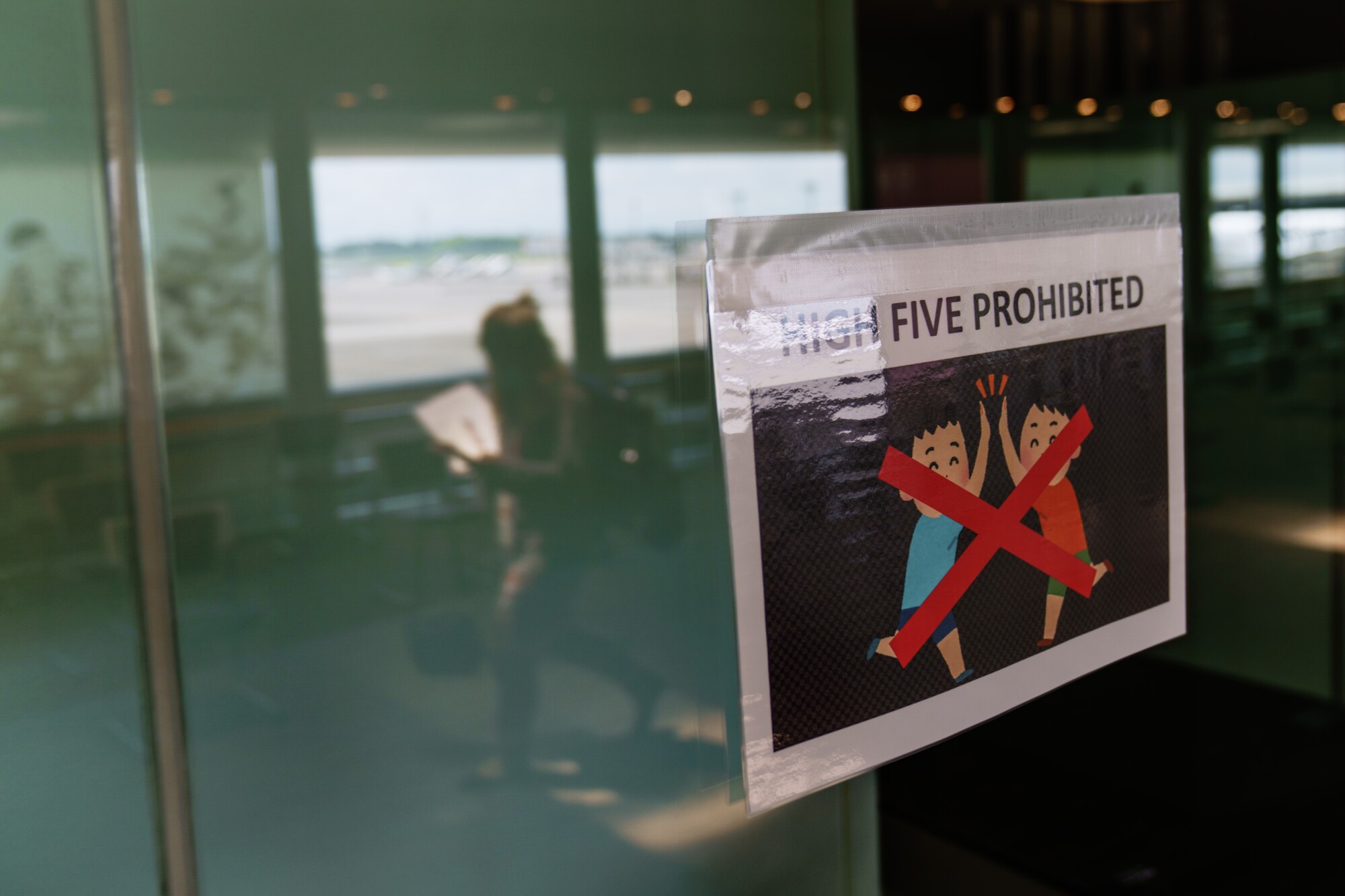 A sign says, "High five prohibited"