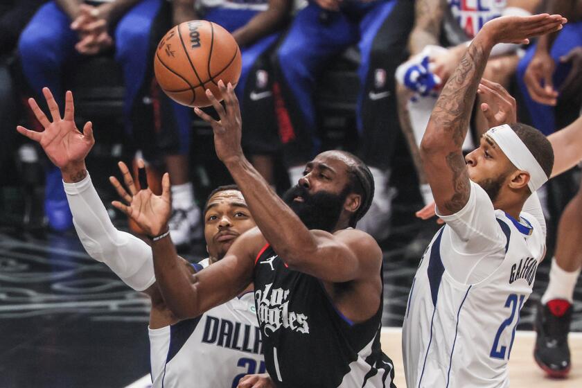 Los Angeles, CA, Tuesday, April 23, 2024 - LA Clippers guard James Harden (1) drives past Dallas Mavericks forward P.J. Washington (25) and center Daniel Gafford (21) for a first half attempt in game two of the NBA Western Conference playoffs at Crypto.Com Arena. (Robert Gauthier/Los Angeles Times)