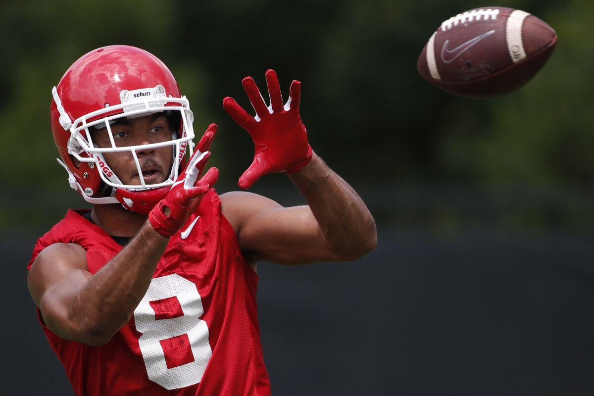 FILE - Georgia wide receiver Dominick Blaylock (8) looks to make a catch during an NCAA football preseason practice in Athens, Ga., in this Friday, Aug. 2, 2019, file photo. The NCAA football oversight committee is preparing to recommend changes to preseason camp that will include fewer fully padded practices and the elimination of some old-school collision drills. The football oversight committee 's initial proposal called for at least nine of a team's 25 preseason practices to be run with players wearing helmets but no other pads, and no more than eight fully-padded, full-contact practices. (Joshua L. Jones/Athens Banner-Herald via AP, File)/