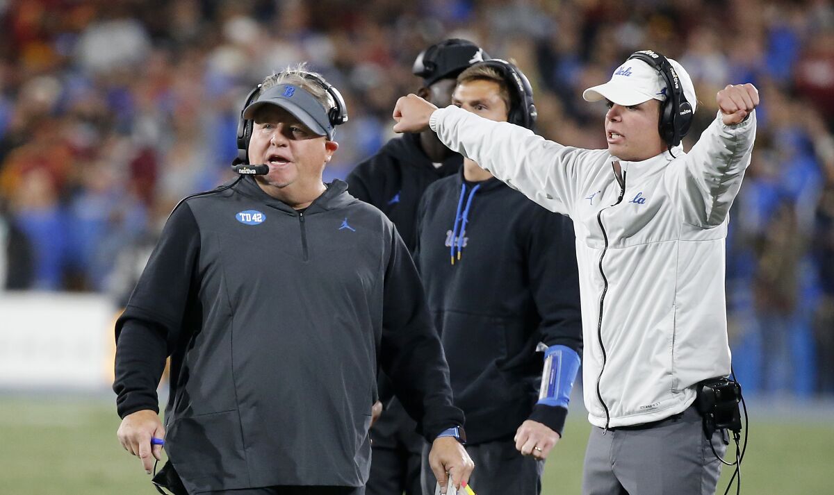 UCLA coach Chip Kelly, left, walks the sideline during the second half of Saturday's loss to USC in the Rose Bowl.