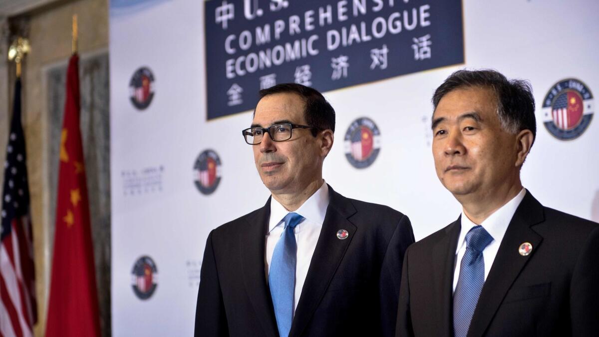Treasury Secretary Steven T. Mnuchin, left, and Chinese Vice Premier Wang Yang appear at the Treasury Department in July 2017.