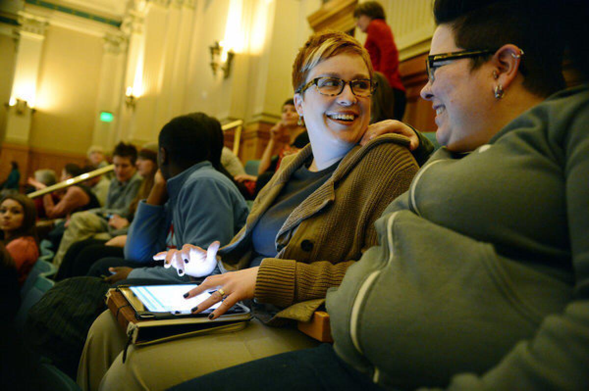 Stephanie Huston, left, and her partner, Robyn Henderson-Espinoza, wait for the vote on civil unions at the Colorado state Capitol in Denver this month. The bill is set to be signed into law Thursday.