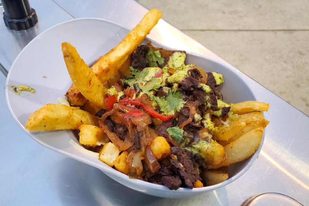 The lomo saltado fries, served in a batting helmet.