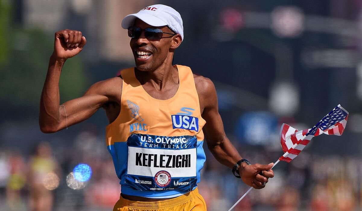 Meb Keflezighi celebrates as he approaches the finish line during the U.S. Olympic marathon trials.