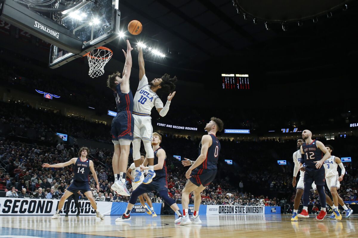 UCLA guard Tyger Campbell puts up a shot over the defense of Saint Mary's forward Kyle Bowen.