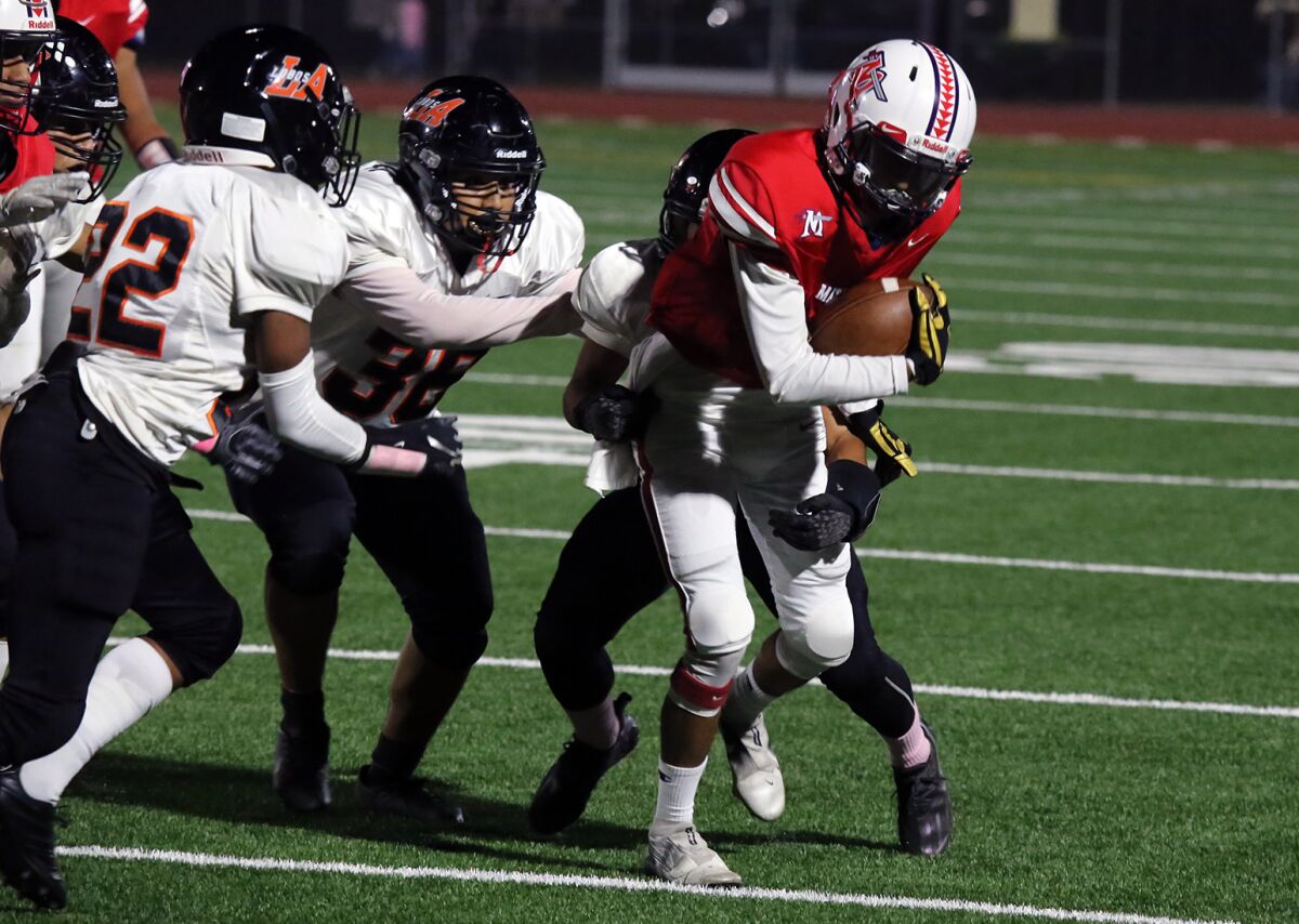 Bolsa Grande's Joel Chavez tries to gain a few yards in the first quarter against Los Amigos.