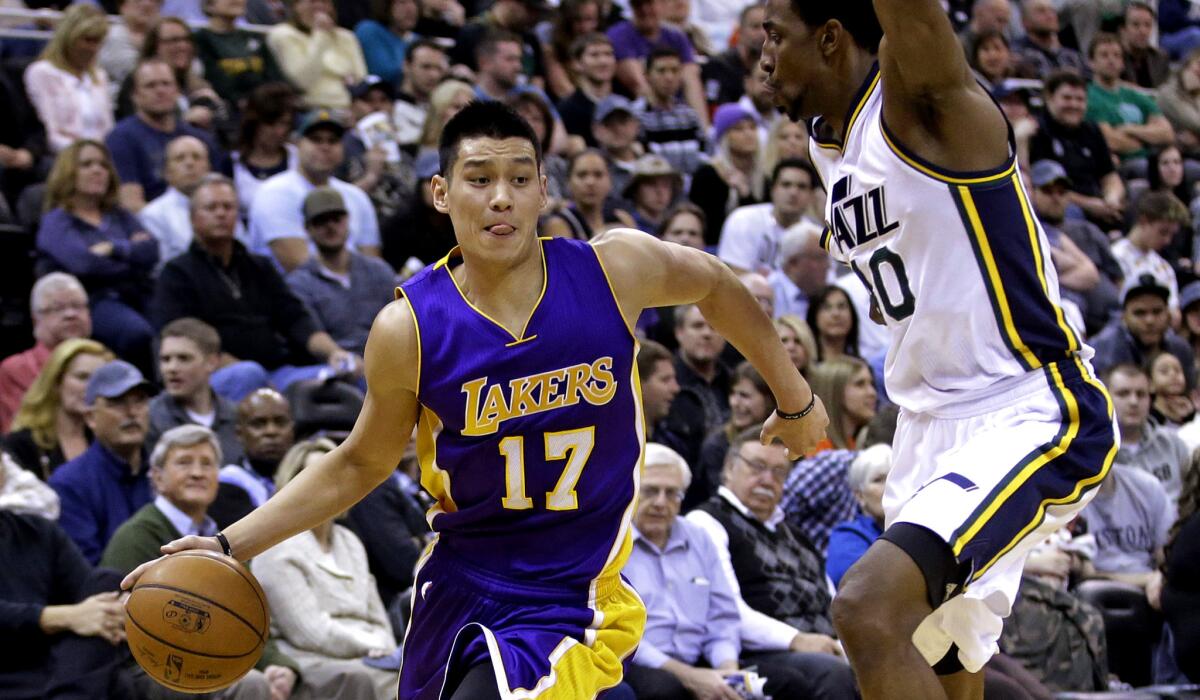 Lakers guard Jeremy Lin drives around Jazz forward Jeremy Evans in the second quarter of a game Wednesday in Utah.